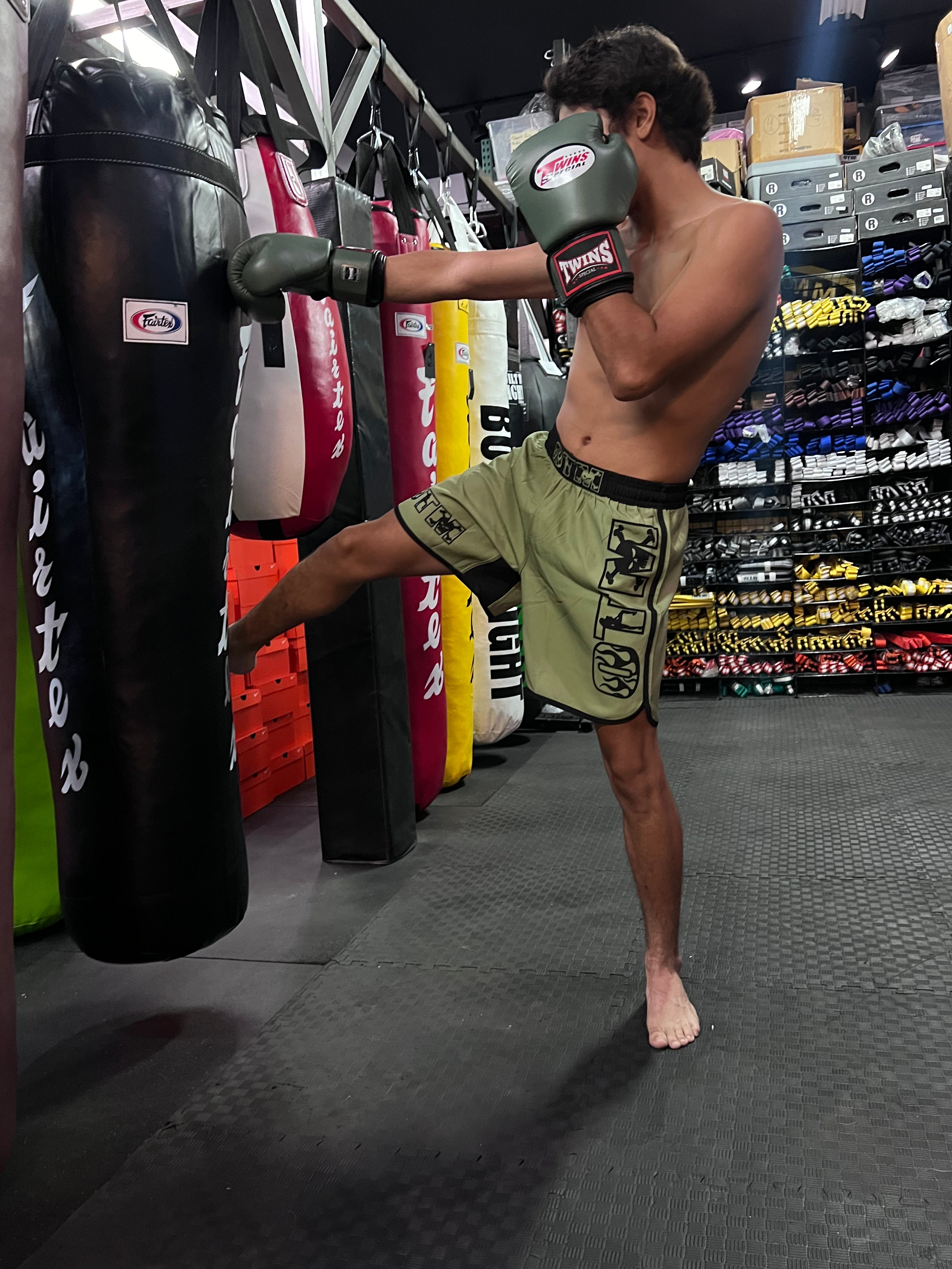 Fighter wearing OTM FHS Fight Shorts during kickboxing training, showcasing flexible fit and durable stitching