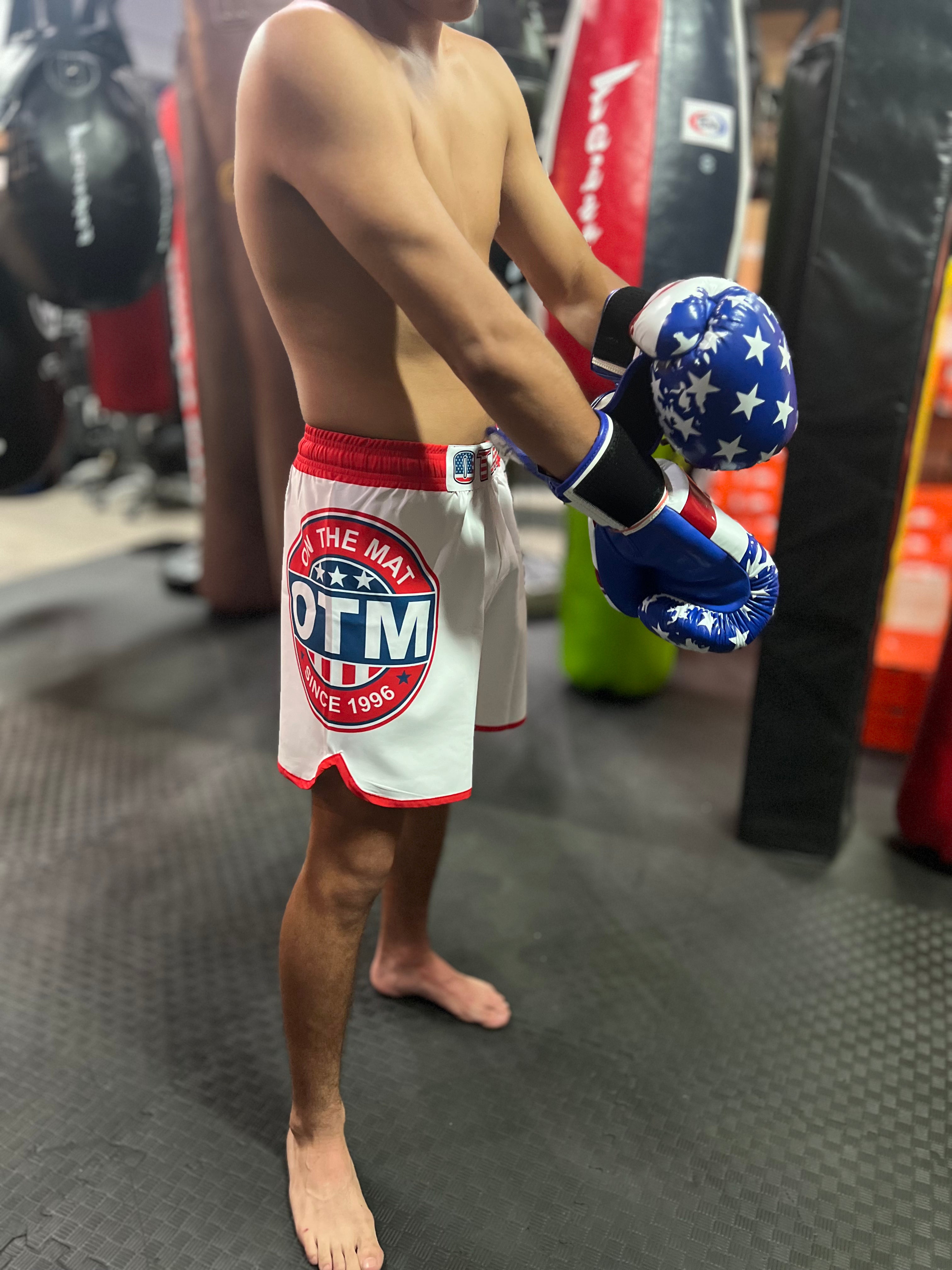Athlete wearing OTM USA Fight Shorts during MMA training, showcasing durable 4-way stretch design and USA graphics